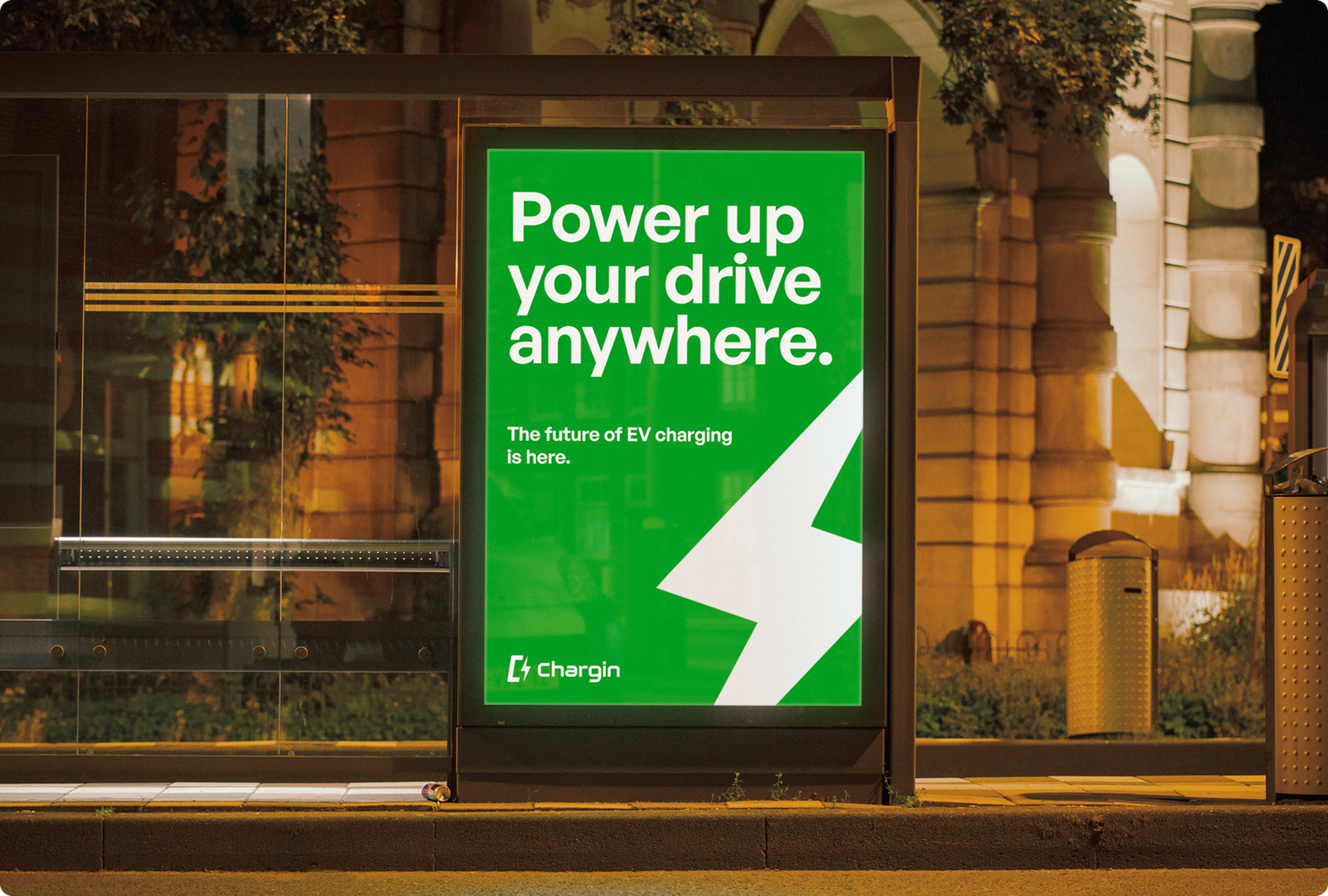 Chargin bus-shelter advertisement — Power up your drive, anywhere